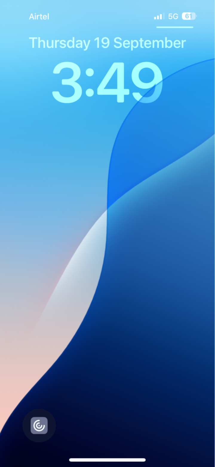 An iPhone displayed against a blue background, featuring a prominent clock on its screen.